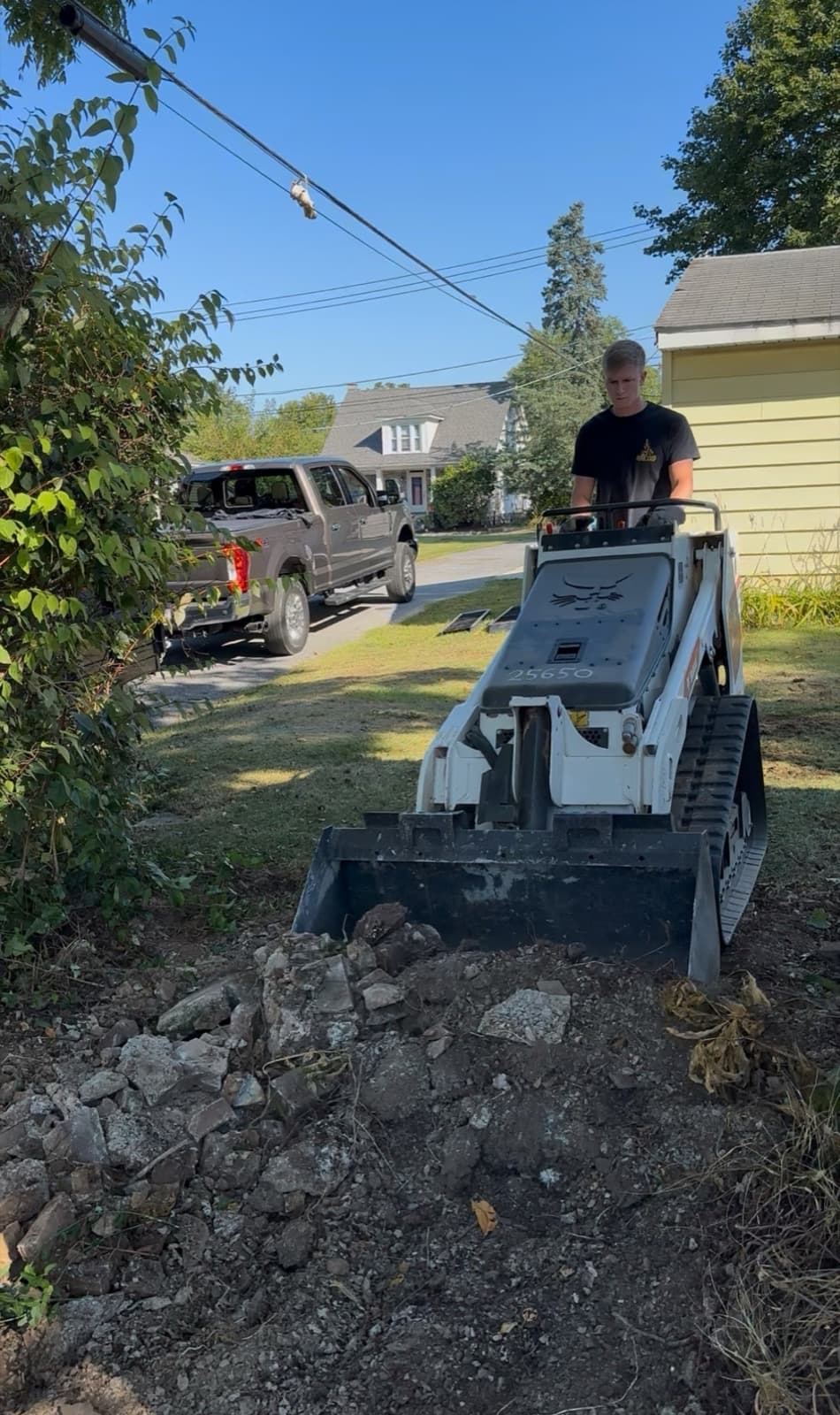William operating a mini-skid loader on a concrete rubble cleanup in York County, PA — The Junk Lord