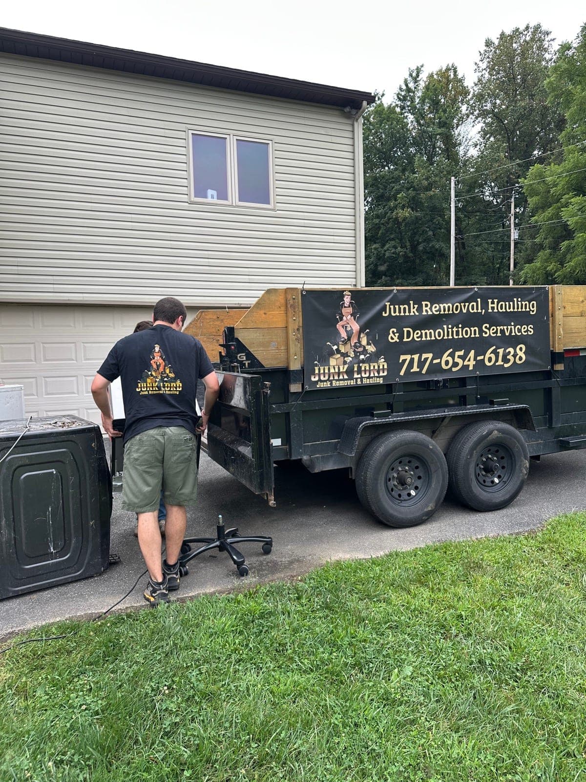 William next to the branded Junk Lord dump trailer with a washing machine staged on a York County, PA driveway