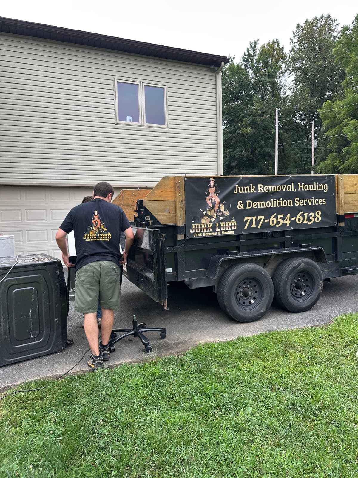 William next to the branded Junk Lord dump trailer with a washing machine staged on a York County, PA driveway