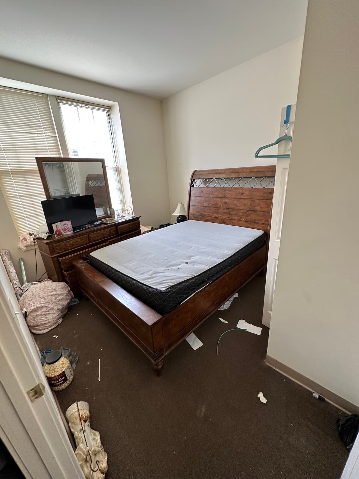 Estate cleanout bedroom in York County, PA stripped down to the bed frame, bare mattress, and a dresser before the final sweep