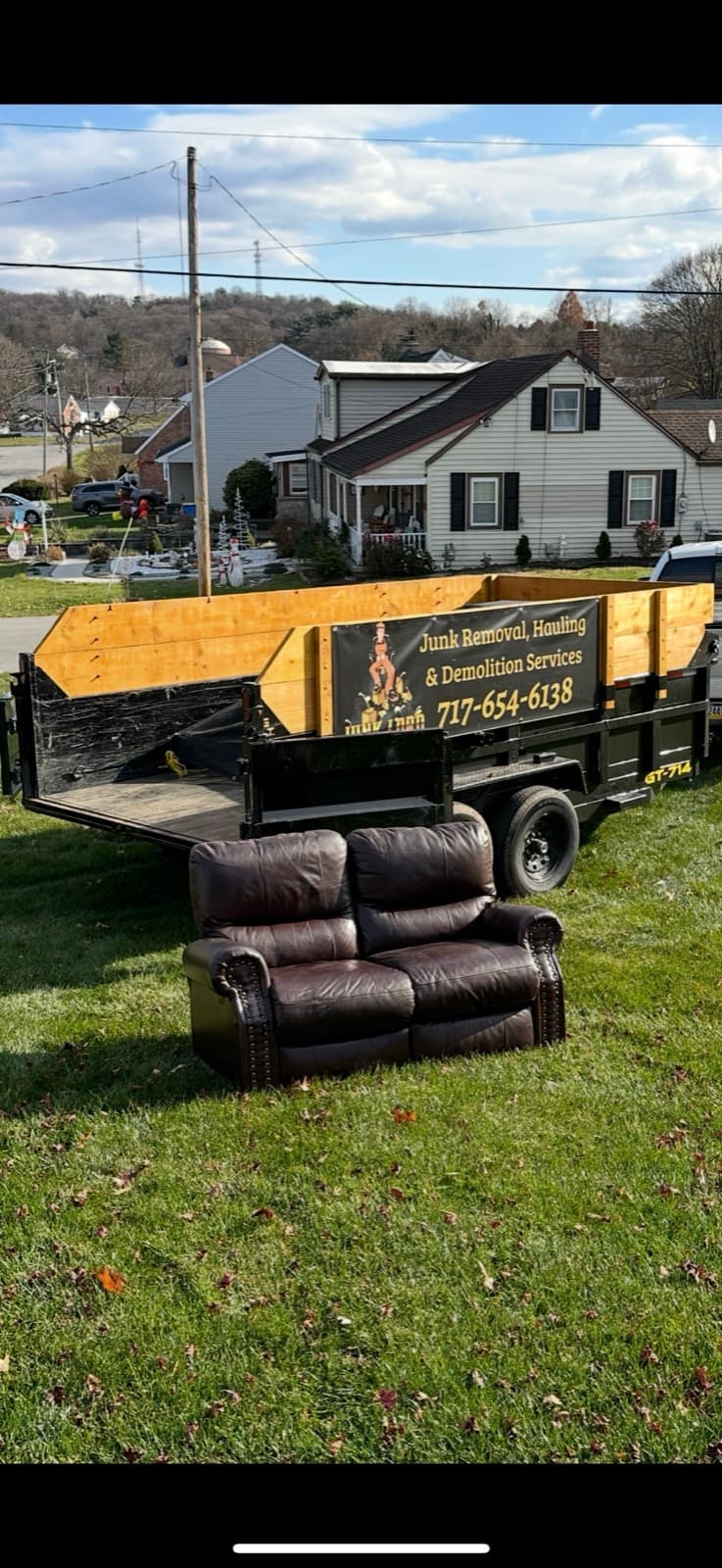 Brown leather recliner staged on a driveway for haul-away in York County, PA — The Junk Lord