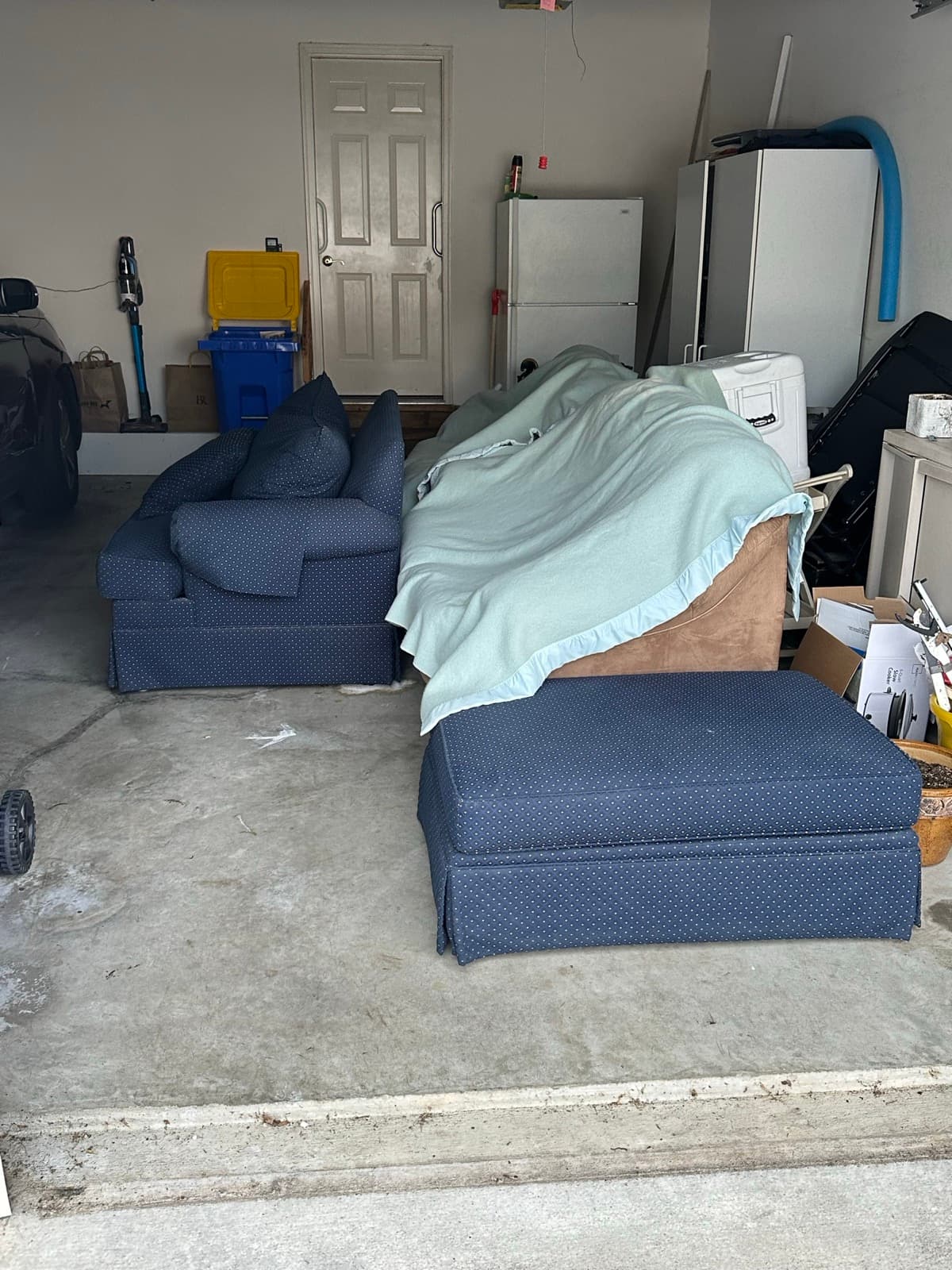Garage interior with couches, a mattress, and an old washer ready for haul-out in York County, PA — The Junk Lord
