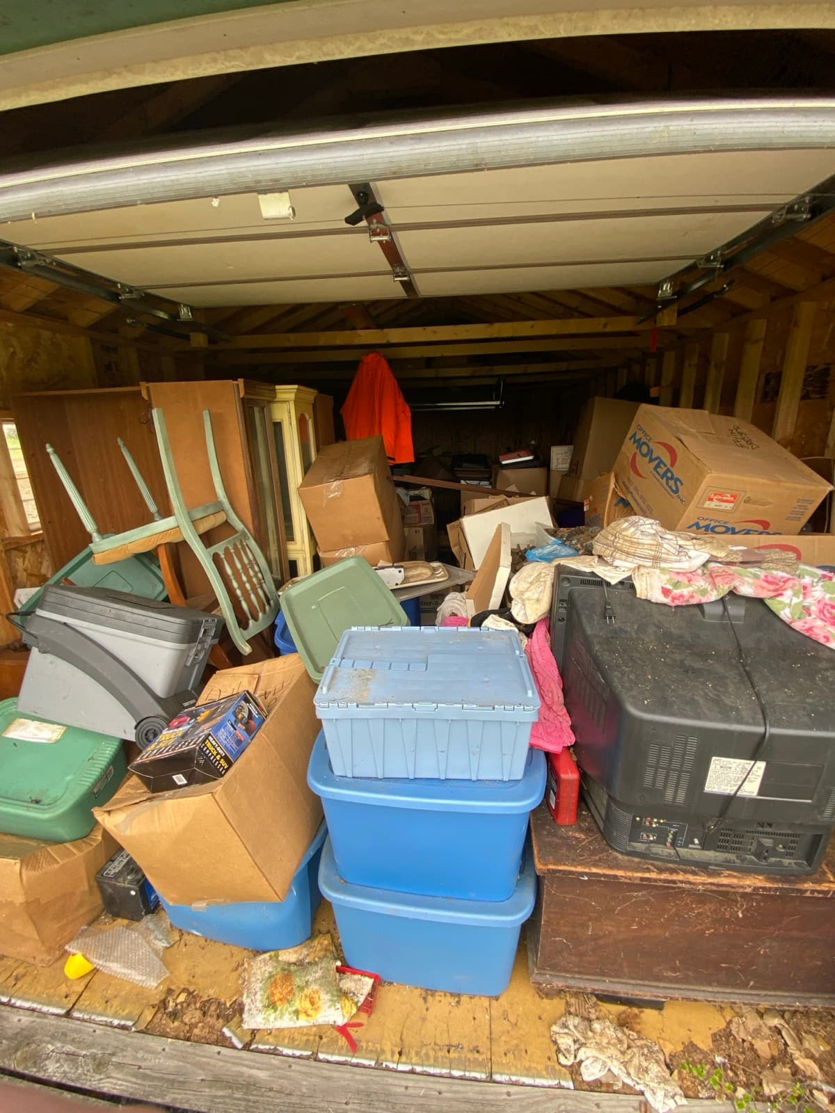 Storage shed packed wall-to-wall with boxes, totes, and household goods staged for The Junk Lord crew in York County, PA