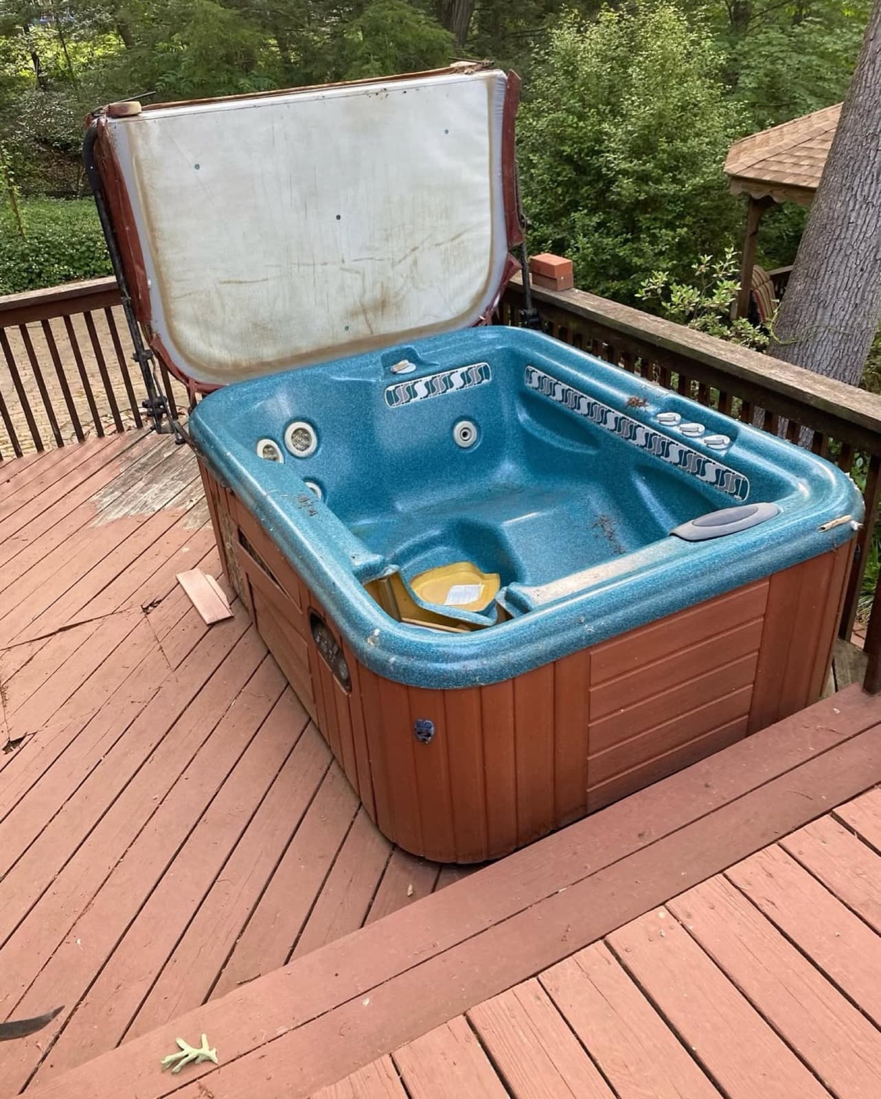Intact backyard hot tub with the lid raised before a Junk Lord removal in York County, PA
