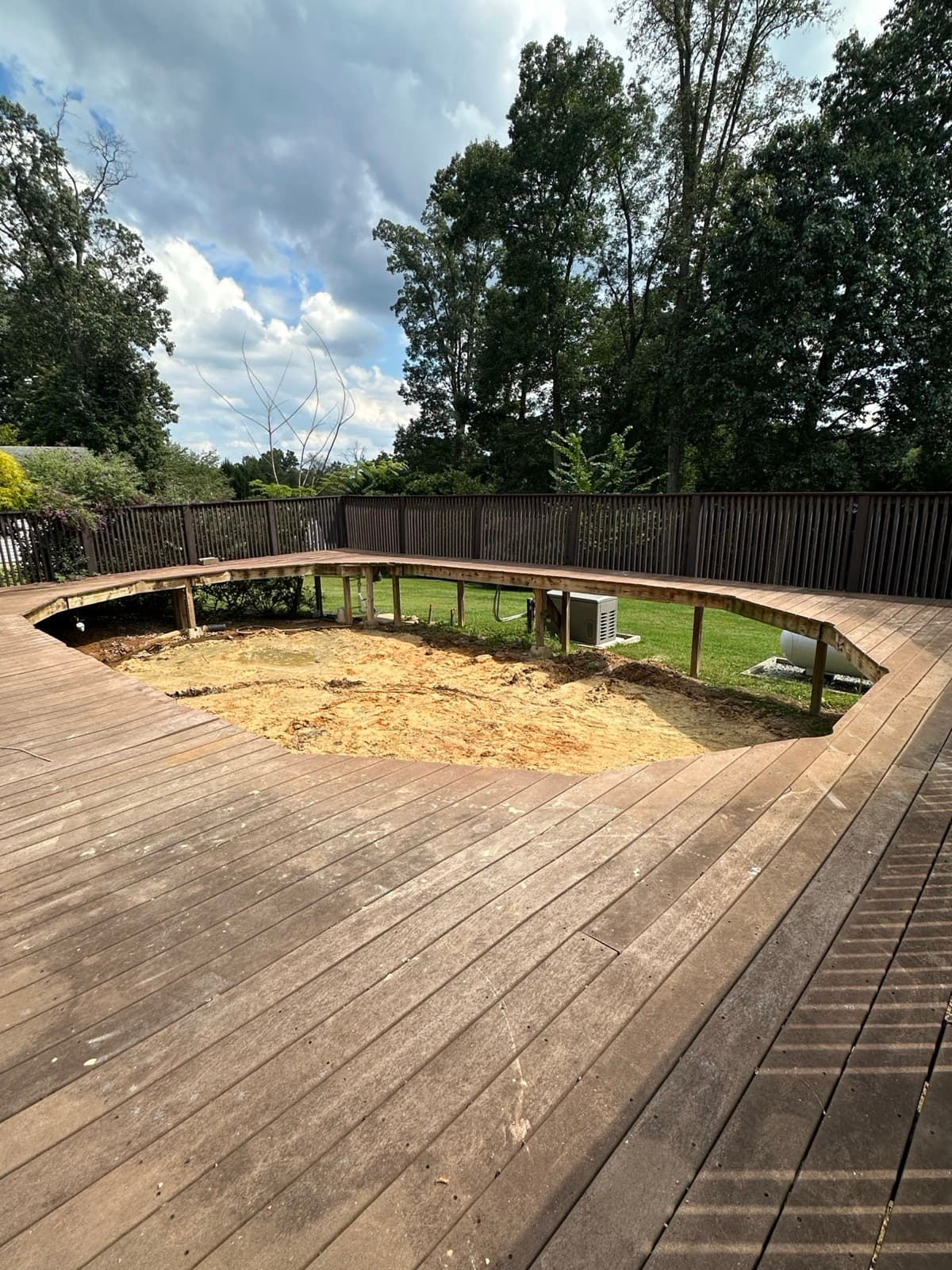 Bare sand footprint framed by the wooden deck opening where the above-ground pool stood — The Junk Lord, York County PA