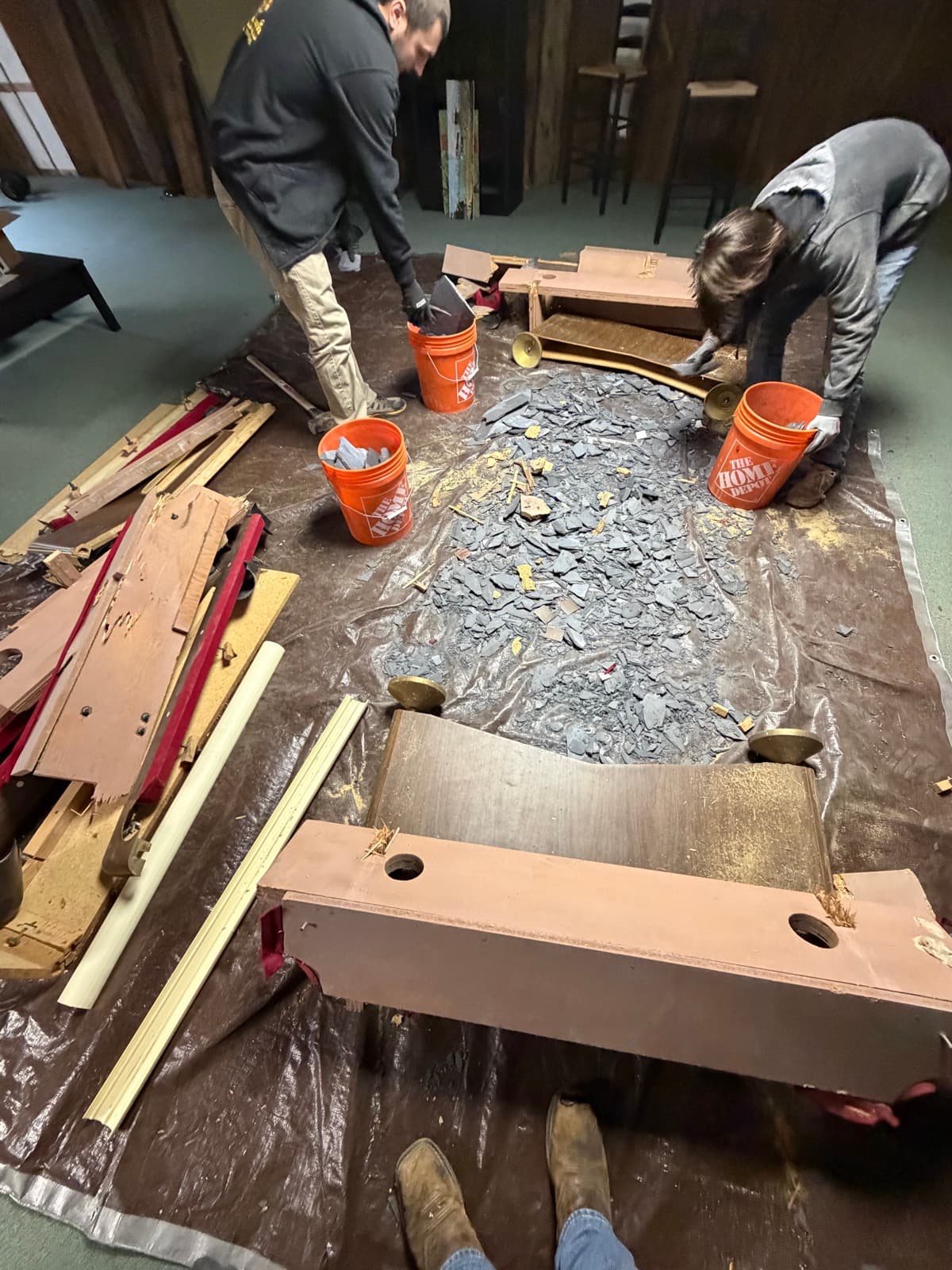 William and crew dismantling a pool table on protective tarps in a York County rec room — The Junk Lord