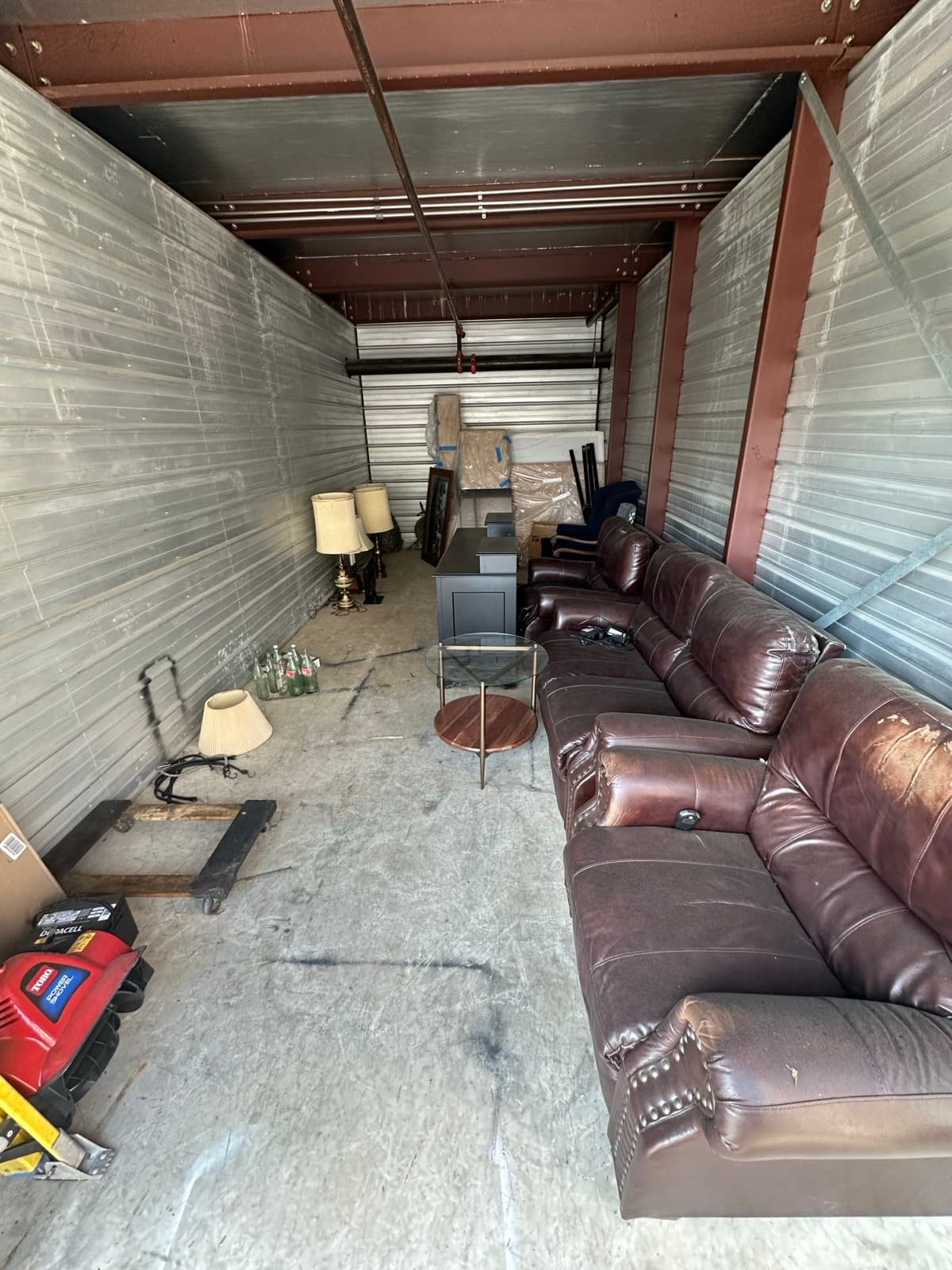 Storage unit packed with leather couches and household items pre-cleanout — The Junk Lord, York County PA
