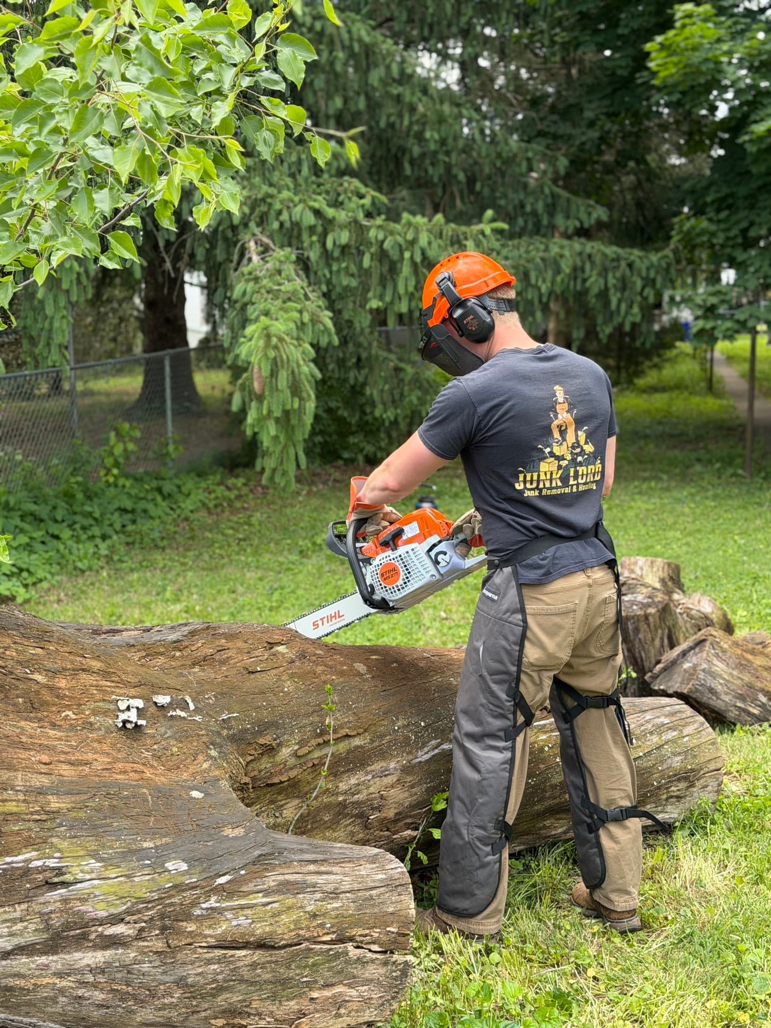 Storm cleanup in progress — The Junk Lord crew sizing down downed limbs