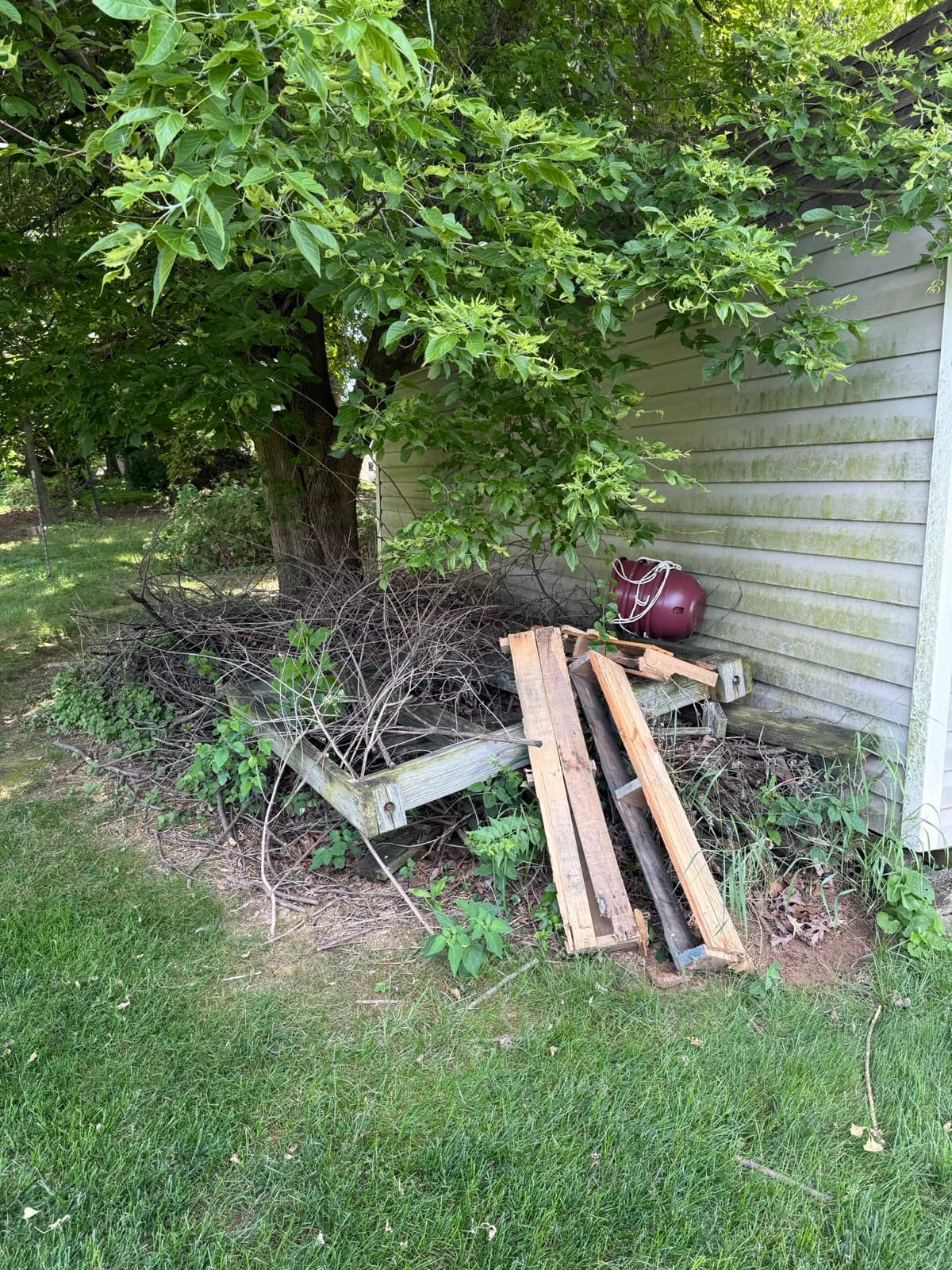 Pile of fence and wood debris in a York County, PA yard before a Junk Lord haul-away